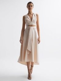 Reiss REBECCA FITTED HIGH RISE MIDI SKIRT in Nude – feminine summer occasion clothes – pale pink tie waist asymmetric hemline skirts – drapey event fashion