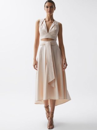 Reiss REBECCA FITTED HIGH RISE MIDI SKIRT in Nude – feminine summer occasion clothes – pale pink tie waist asymmetric hemline skirts – drapey event fashion - flipped