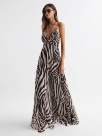 REISS VIDA ZEBRA PRINT MAXI DRESS in BLACK/WHITE – glamorous evening resort clothes – strappy occasion dresses with animal prints – plunge front event clothing – cut out back fashion