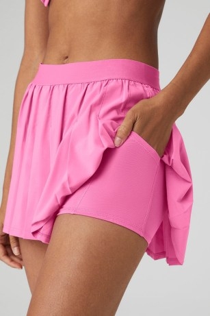alo yoga VARSITY TENNIS SKIRT in PARADISE PINK ~ pleated sports skirts with built in shorts ~ women’s sportwear clothes - flipped