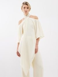 TALLER MARMO Sade off-the-shoulder pointed-hem crepe top ~ fluid ivory asymmetric hemline tops ~ chic asymmetrical occasion clothes
