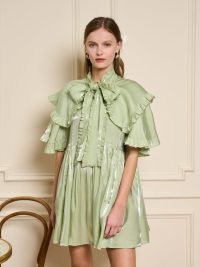 sister jane THE MADELEINE MOMENT Cheri Bow Mini Dress in Pistachio Green ~ shimmering ruffled relaxed fit dresses ~ occasion fashion with an oversized neck tie detail ~ romantic party clothes