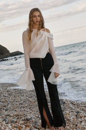 Aje. Edith Draped Top in Champagne Cream ~ asymmetrical semi sheer tops ~ luxe oversized fluted cuff blouse ~ contemporary fashion ~ feminine asymmetric one shoulder blouses
