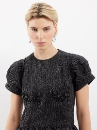 SIMONE ROCHA Crystal-flower metallic-cloqué mini dress in black – shimmering short sleeve floral detail fit and flare – sparkly short length structured dresses