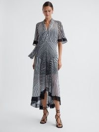 REISS ANAYA CHECK REMOVABLE NECK TIE MIDI DRESS in BLACK / WHITE – flowing asymmetric dresses – monochrome print occasion clothing