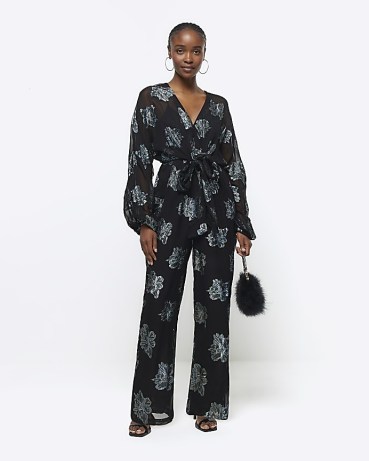 RIVER ISLAND Black Glitter Floral Belted Jumpsuit ~ glittering sheer sleeve tie waist jumpsuits ~ women’s all in one party fashion - flipped