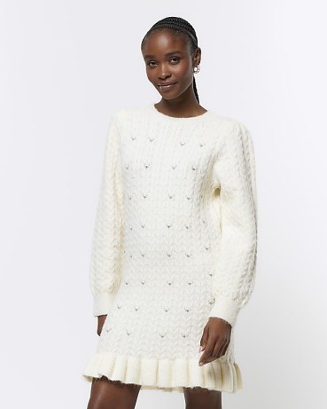 River Island Cream Cable Knit Jumper Mini Dress | women’s knitted long sleeve ruffle hem dresses | embellished knitwear fashion - flipped