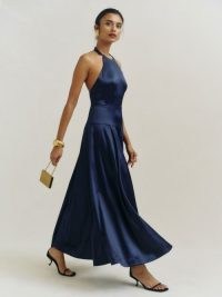 Reformation Lilyann Satin Dress in Navy – silky dark blue fit and flare halterneck maxi dresses – luxe halter occasion fashion – women’s luxury event clothing