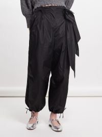 Simone Rocha Rose-appliqué nylon trousers in black ~ women’s relaxed floral detail cuffed hem trouser