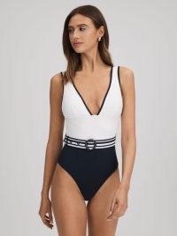 REISS WILLOW COLOURBLOCK BELTED SWIMSUIT in WHITE/NAVY / white and navy blue colour block high leg swumsuits / deep plunge front swimwear